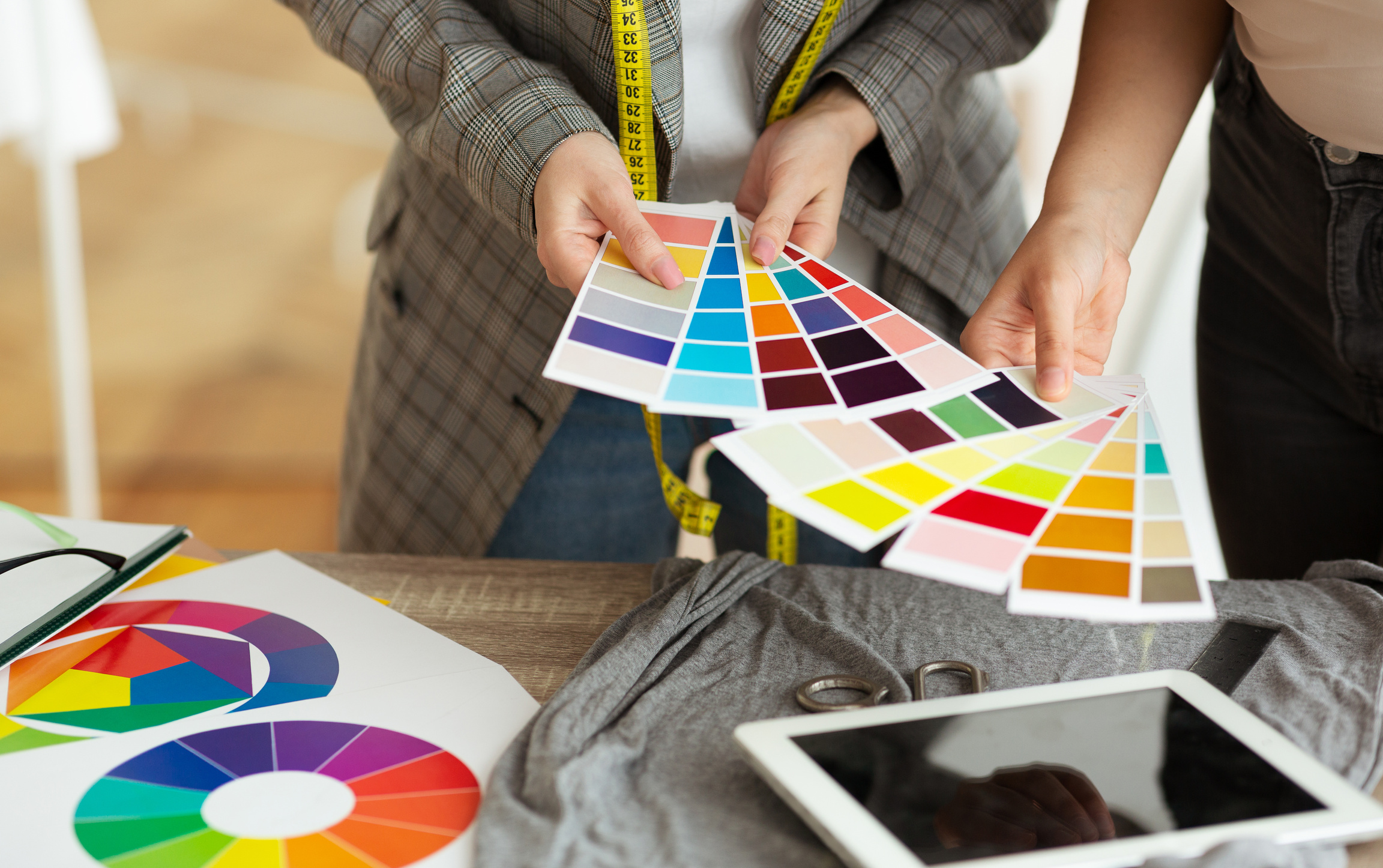 Female fashion stylist and customer holding color samples