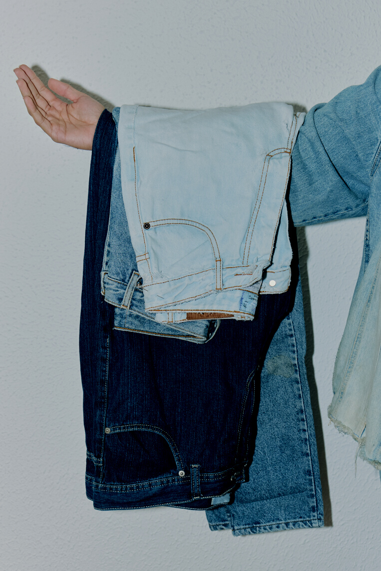 Denim Pants Hanging from a Person's Arm